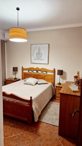a bedroom with a bed and two night stands and two lamps at Villa Do Mar in Porches