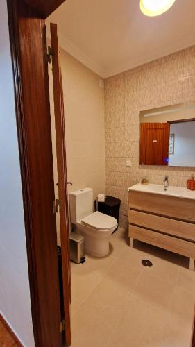 a bathroom with a toilet and a sink and a tub at Villa Do Mar in Porches