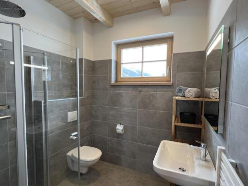 a bathroom with a shower toilet and a sink at Haus Bente in Donnersbachwald