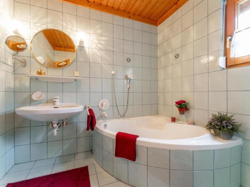 a bathroom with a tub and a sink at Landhaus zur Sonne in Diex