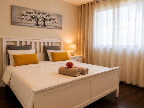a bedroom with a white bed with two towels on it at Bom dia Parque Nações Lisboa W in Lisbon