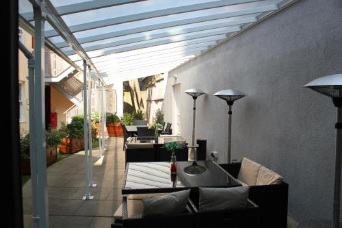 a patio with a couch and a table on a patio at Grand Plaza Serviced Apartments in London