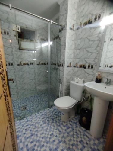 a bathroom with a shower and a toilet and a sink at Apprt Ennakhil 3 in El Jadida