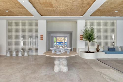 a living room with a table and a couch at Patmos Aktis, a Luxury Collection Resort & Spa, Greece in Patmos