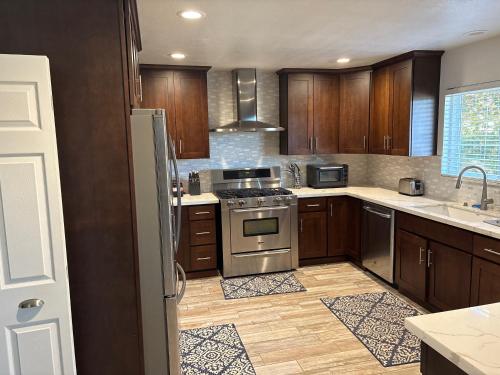 a kitchen with wooden cabinets and a stove top oven at 907 elm in Rodeo