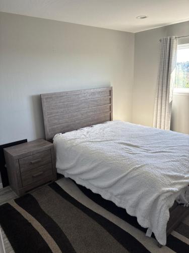 a bedroom with a white bed and a window at 907 elm in Rodeo