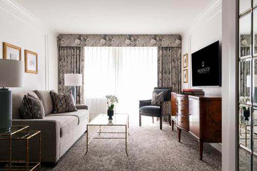 a living room with a couch and a chair at Wedgewood Hotel & Spa - Relais & Chateaux in Vancouver