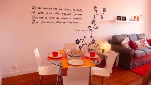 a living room with a table and a couch at Apartment terrace Castelo S.Jorge in Lisbon