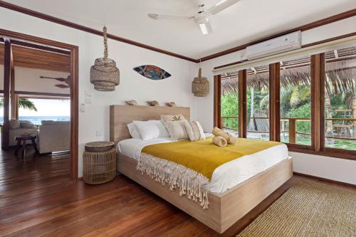 a bedroom with a bed with a teddy bear on it at Marbella Mentawai Beachfront Private Villa Sleeps 10 in Katiet