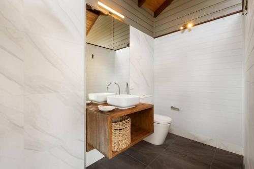 a bathroom with a sink and a toilet at Mini Mullum Studio Retreat in Mullumbimby