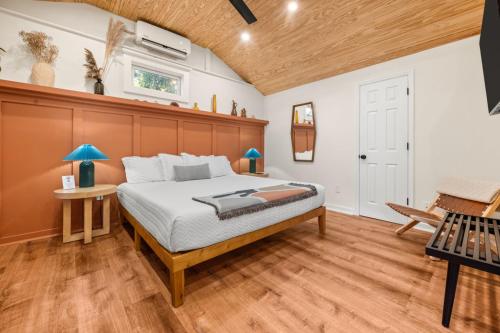 a bedroom with a bed with a wooden headboard at Madeira Cottage - Amphitheater in St. Augustine