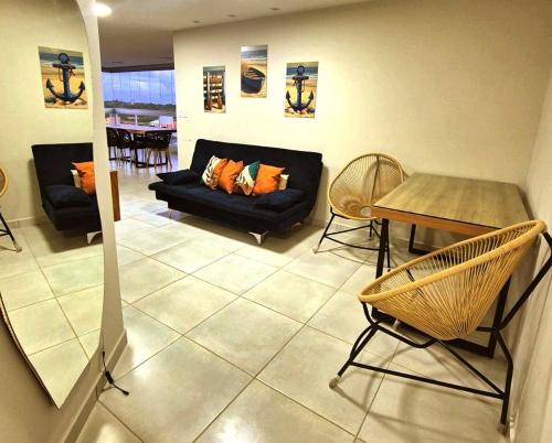 a living room with a couch and a table at Salt Beach Atalaia Fort do Farol in Salinópolis