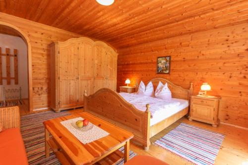 a bedroom with a bed in a log cabin at Frühstückspension Müllergut in Sankt Martin bei Lofer