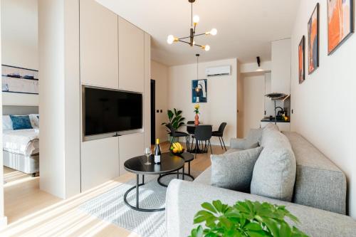a living room with a couch and a table at Vrtovi Boke by Montena in Dobrota