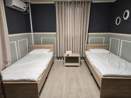 two twin beds in a room with at 지슬스테이 in Pyoseon
