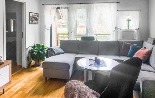 a living room with a couch and a table at Nice Apartment In Rysstad With Wifi in Rysstad