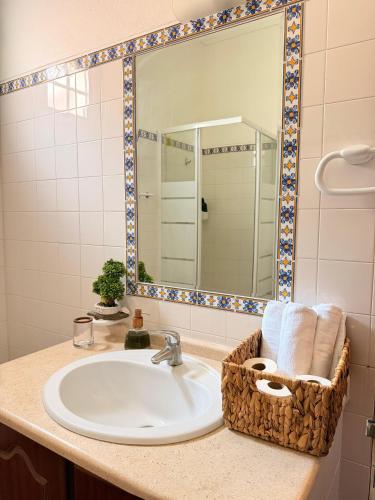 a bathroom with a sink with a mirror and towels at Herdade do Corval in Reguengos de Monsaraz