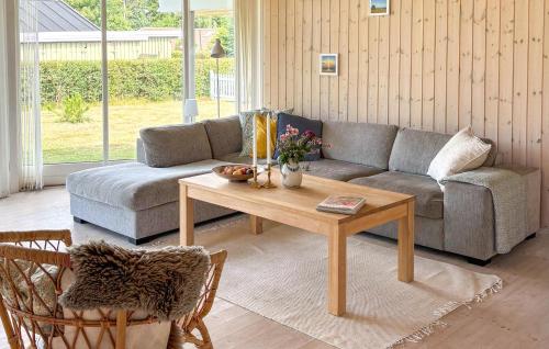 a living room with a couch and a coffee table at Nice Home In Væggerløse With Wifi in Bøtø By