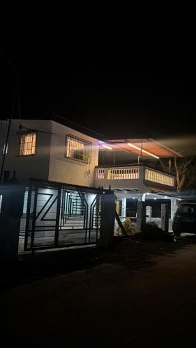 a building at night with a car parked in front of it at Prince Villa in Neral