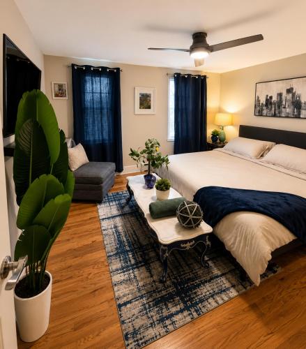 a bedroom with a large bed and a couch at CrazyHart PVD in Providence