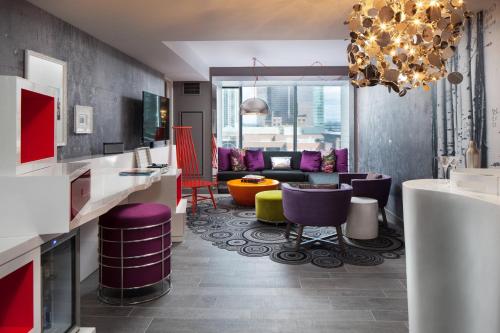 a living room with colorful chairs and a couch at W Bellevue in Bellevue