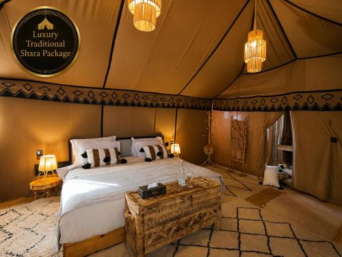 a bedroom with a bed in a safari tent at Luxury Traditional Sahara Package in Merzouga