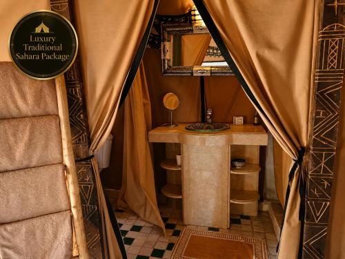 a small room with a table and a mirror at Luxury Traditional Sahara Package in Merzouga