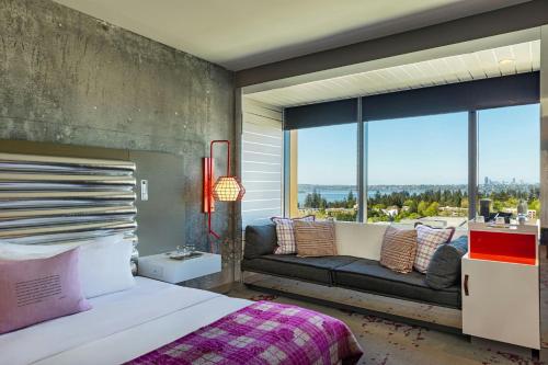a bedroom with a large window with a bed and a couch at W Bellevue in Bellevue