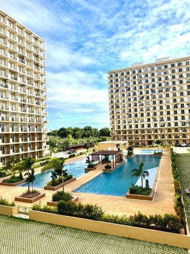 a view of two large buildings and a swimming pool at Claire's Empire in Lapu Lapu City