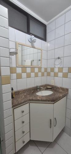 a bathroom with a sink and a mirror at Praia do Forte - AP DA PAZ in Cabo Frio