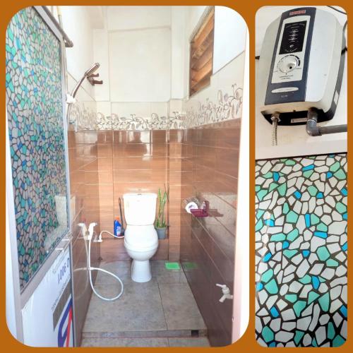 a bathroom with a toilet and a shower at City Lavish in Nuwara Eliya