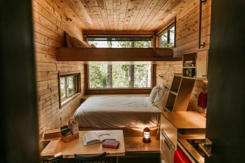 a bedroom in a log cabin with a bed and a desk at Postcard Cabins Shenandoah, Outdoor Collection by Marriott Bonvoy in Stanardsville