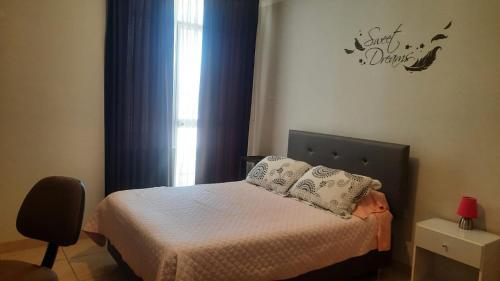 a small bedroom with a bed and a window at Hospedaje Kelita in Moquegua