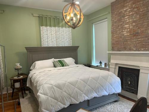 a bedroom with a bed with a fireplace and a chandelier at Catherine's Palace in Vicksburg