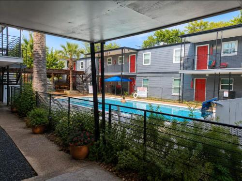 a house with a swimming pool with plants and a fence at ATX Casa Tranquila in Austin