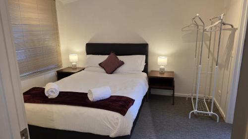 a bedroom with a large bed with two night stands at Alpinwood in Dinner Plain