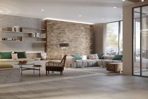 a living room with a couch and a table at Wyndham Garden Sartell/St. Cloud in Sartell