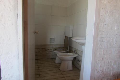 a bathroom with a toilet and a sink at Los Monos in La Pedrera