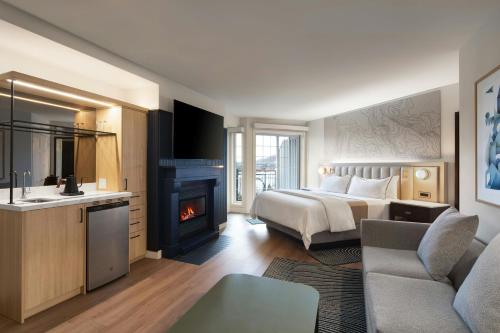 a hotel room with a bed and a fireplace at Le Westin Tremblant in Mont-Tremblant