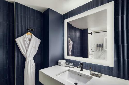 a bathroom with a white sink and a mirror at Le Westin Tremblant in Mont-Tremblant