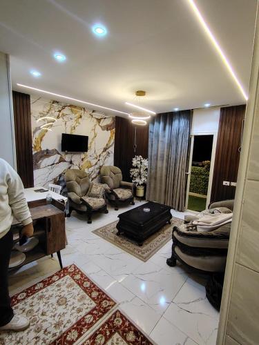 a large living room with a stone wall at شقة للإيجار طنطا in Tanta
