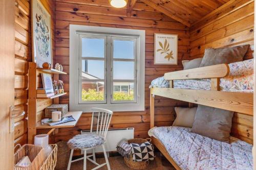 a bedroom with two bunk beds and a window at G256-Lemvig-Bellisvej-56 in Lemvig
