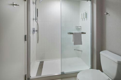 a bathroom with a glass shower with a toilet at Boston Marriott Peabody in Peabody