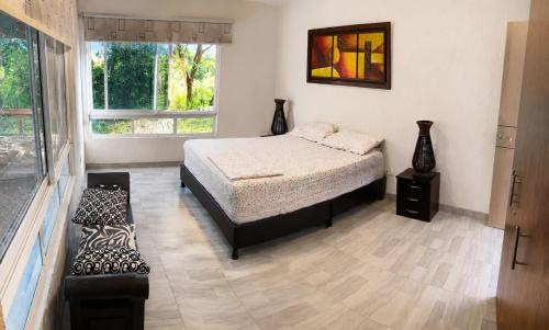 a bedroom with a bed and a window at Finca El Balmoral in Tocaima
