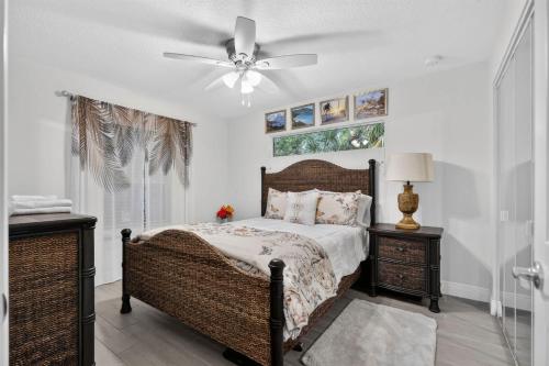 a bedroom with a bed and a ceiling fan at Abi's House - Private Jupiter Escape in Jupiter