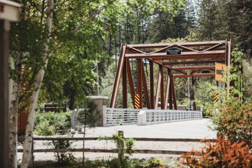 a bridge over a walkway in a park at The Cottages at Bigfork in Bigfork
