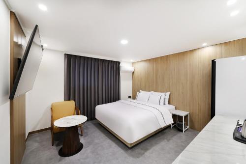 a hotel room with a bed and a table at 서천 마리 호텔 in Seocheon