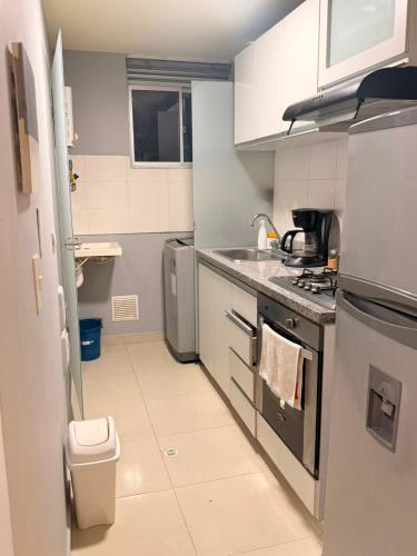 a small kitchen with a sink and a stove at Sky Luxury Suites in Bucaramanga