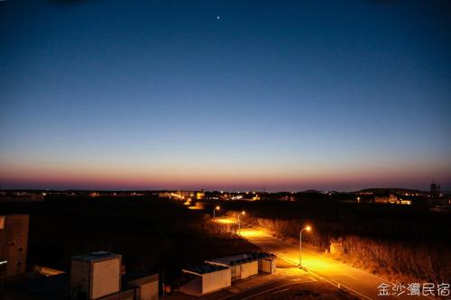 una vista di una città di notte con i lampioni di Jinshawan B&B a Magong