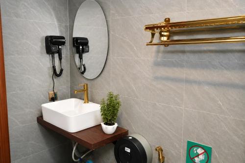 a bathroom with a sink and a mirror at Bliss & Beats Hostel in Phnom Penh